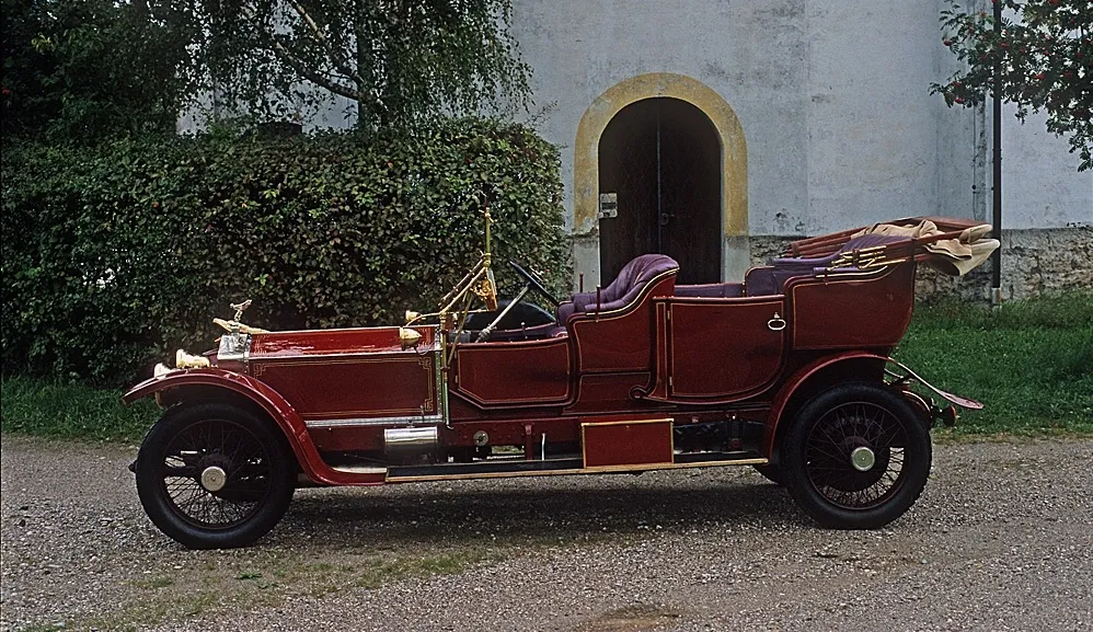 27NA parked before an arched church doorway, photographed in the early 1980s in its restored Roi-des-Belges tourer coachwork.