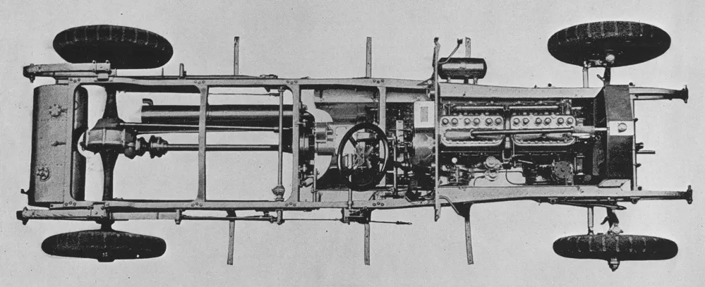A top-down factory photograph of a 1913 Rolls-Royce Silver Ghost rolling chassis, showing the frame, engine, cardan shaft and all four wheels.
